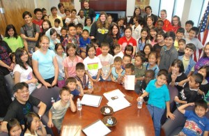 Students and their families who participated in the Kent School District's Refugee Transition Center Summer Program fill up the office of Superintendent Edward Lee Vargas during a Aug. 17 visit.