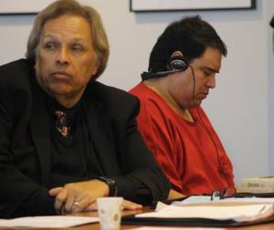 Telesforo Hernandez-Roa lowers his head as defense attorney Robert Perez watches speakers prior to the Friday sentencing in Kent of Hernandez-Roa to 16 years in prison for the murder of his ex-wife in July 2014. The headset provided Hernandez-Roa with an interpretation of what the speakers were saying.