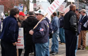Informational pickets from the Machinists Union walk in front of Hytek Finishes March 21 in Kent to support company employees seeking a new contract.