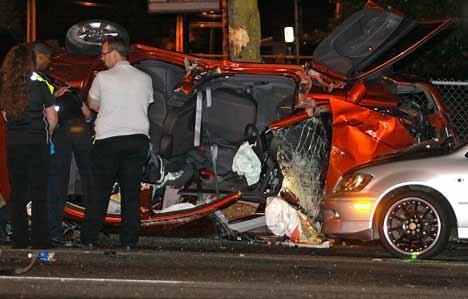 Investigators stand near the wreckage of a severe three-car accident that happened at about 8:46 p.m. Aug. 24 at the intersection of Southeast 208th Street and 108th Avenue Southeast in the Panther Lake area of Kent's East Hill. A man and woman in one of the cars died at the scene.