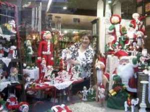 Kent downtown merchant Carol Schwindt adjusts the window display at her store