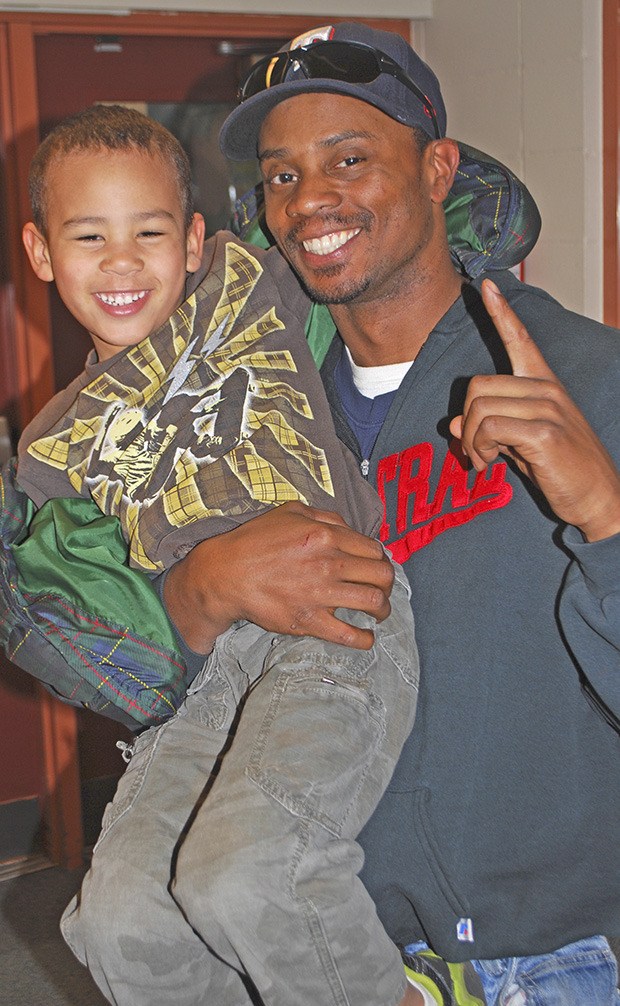 Positive role model: Troy McIntyre holds his son Malik