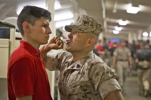 A Marine Corps drill instructor screams at a recruit