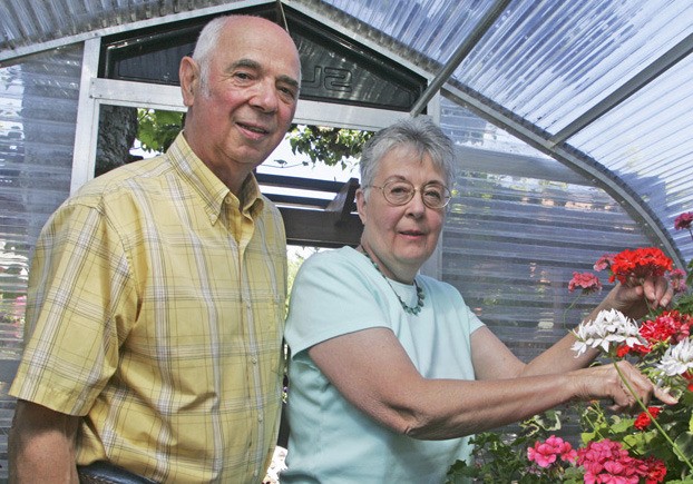 Chuck and Nancy Simpson pose in the garden in their Panther Lake home