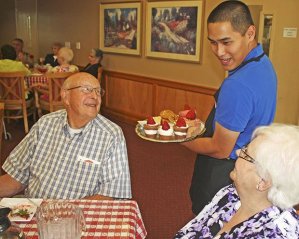 Noah Saylor serves up dessert to Burt Jarvis