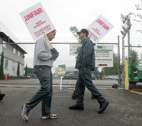 Garbage haulers picket Wednesday at the Waste Management facility in Auburn. Teamsters Local 174 went on strike Wednesday over a contract dispute with the company.
