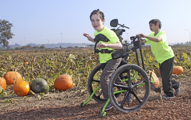Kyle Hinkle gets a push from his fellow classmate