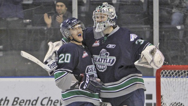 Luke Lockhart and goalie Brandon Glover celebrate the win.