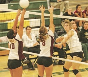 Kentridge's Chelsea Thompson (right) powers the ball through Thomas Jefferson blockers Kendra Ansotigue (10) and Megan Levesque. Kentridge beat Thomas Jefferson in four games on Tuesday 25-16