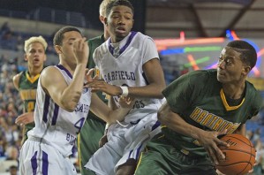 Tough crowd: Kentridge’’s Jawan Stepney looks to pass the ball against Garfield’s collapsing defense during first-round state Class 4A play at the Tacoma Dome on March 6. The Chargers lost the battle