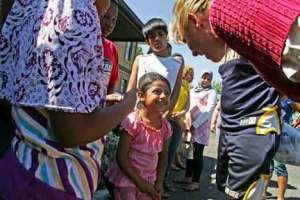 County Councilmember Julia Patterson stops to befriend a youngster June 30 at Kent Youth & Family Services