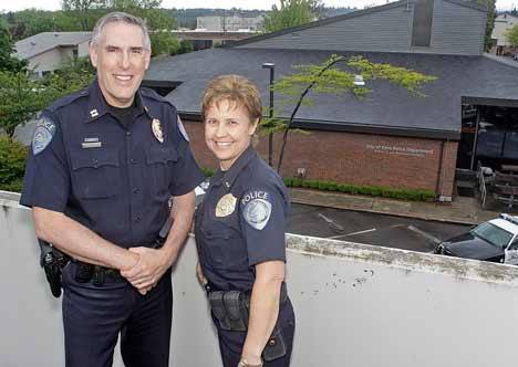 Kent Police Capt. Ron and Lt. Lisa Price pose atop the Centennial Building Parking Garage with Kent Police Station behind them May 21. They will be leaving Kent for Montana