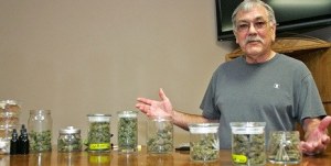 Charles Lambert behind the counter at the Evergreen Association of Community Garden July 26 in Kent where he distributes medical marijuana to patients.