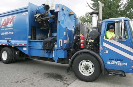John Egan Jr. drives an Allied Waste recycling truck last summer. The Kent City Council on March 16 selected Allied Waste over two other companies to receive the city's new garbage and recycling contract starting next year.