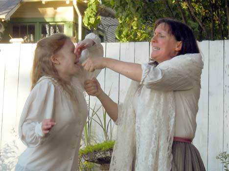 Life as a pioneer: This sickly young girl gets a strong dose of medicine from her well-intentioned grandmother in 'A Living History Performance - Saar Pioneer Cemetery
