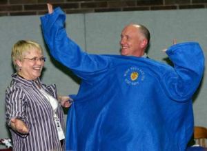 Police Chief Steve Strachan puts on a custom-made Kent Police “Snugglie” from Administrative Assistant Jo Thompson Dec. 17