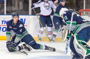 Thunderbirds defenseman Turner Ottenbreit looks back as goalie Logan Flodell makes a save during WHL play against Tri-City on Friday night.