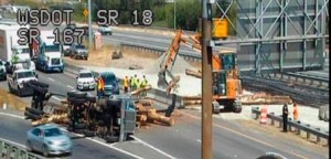 A log truck dumped its load along southbound Highway 167 on Thursday afternoon