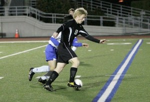 Kentlake’s Greg Gordon works his way around a Kent-Meridian defender during a game on March 22.