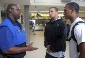 Washington State School Security Officer of the Year Dave Fowler talks with Devin Topps and Alex Ferguson during lunch Sept. 26. Topps and Ferguson are both members of the football team and the Kingsmen.