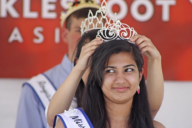 Mithula Rarmal receives the Miss Cornucopia crown from past queen Candy Chang during the coronation at Town Square Plaza on Friday.