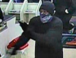 Surveillance footage of an armed robbery suspect