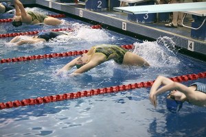 Kentridge freshman Alyssa Miron dives off the blocks at the starts of the 100-yard backstroke. Miron finished second in the race.