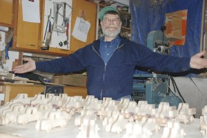Vern Heinle of Kent shows off the work he has completed on wooden cars and trucks for the Forgotten Children’s Fund