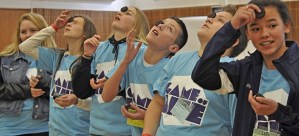 Game of Life Conference participants attempt to move an Oreo cookie from their foreheads to their mouths without using their hands.