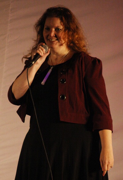 Kent resident Melanie Hope tells her survivor's story at the Purple Lights Night 2011 tree lighting event Saturday in Covington.