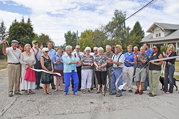 Residents of Kent's Mill Creek neighborhood celebrate as Mayor Suzette Cooke cuts a ribbon to mark the designation of the historic neighborhood as a landmark district last Saturday.