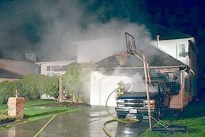 Fire damages a SUV and house on Thursday night in the 24300 block of 129th Avenue Southeast in Kent.