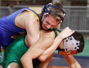 Defending state champion Ruben Navejas of Kentwood (bottom) couldn’t escape the grasp of Tahoma’s Steven Hopkins in the 103-pound championship match on Saturday.