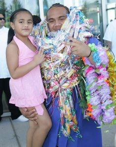 06/11/10 Kent-Meridian graduate Ike Jenningf has lays stack to his ears and poses with his sister Repa outside of ShoWare after the graduation ceremony Saturday