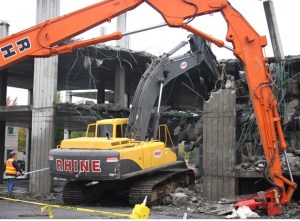 Demolition of the unfinished parking garage in downtown Kent began Monday
