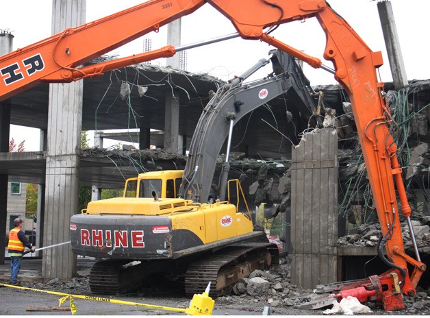Demolition of the unfinished parking garage in downtown Kent began Monday