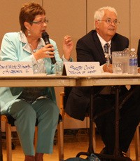 Kent Mayor Suzette Cooke speaks as challenger Tim Clark listens during a Kent Candidate Forum on Monday.