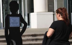 A woman observes a silent witness display Friday