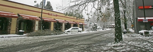 Fallen branches cover downtown Kent Thursday along Meeker Street.