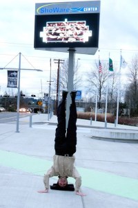 Kent City Councilman Dennis Higgins stands on his head to help promote the ShoWare Center's Marquee Tickets Contest.