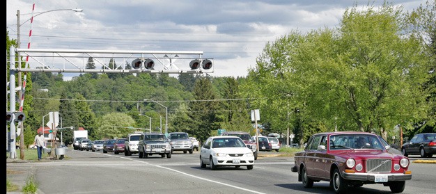 Vehicles head across the railroad tracks along Willis Street in Kent. Kent Police plan emphasis patrols to make sure drivers and pedestrians are following rail crossing laws.
