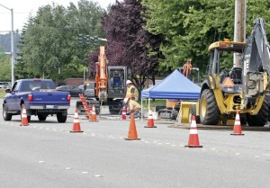 Crews close a lane of traffic westbound Friday on South 228th Street in Kent. Crews will install storm drainage pipe along the street over the next few months.
