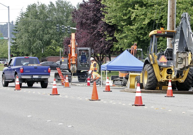 Crews close a lane of traffic westbound Friday on South 228th Street in Kent. Crews will install storm drainage pipe along the street over the next few months.
