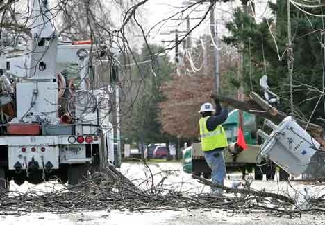 A Puget Sound Energy worker guides a transformer bank to the ground Tuesday