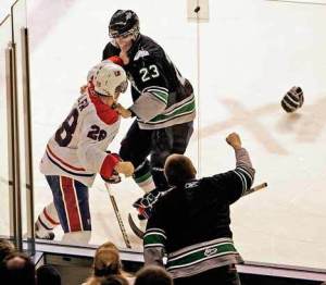 Seattle’s Chance Lund braces for a fight against Spokane right wing Kenton Miller during Tuesday night’s 8-2 loss to the Chiefs at the ShoWare Center.