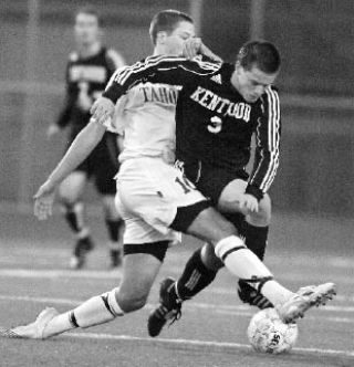 Kentwood’s Matt Eronemo tries to avoid a tackle by Tahoma’s Evan Denmark while both players pursue the ball during last Friday’s game. Tahoma won