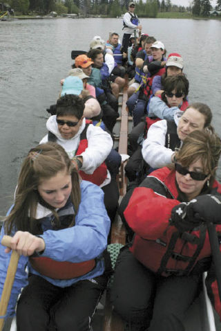 Above: Kent Dragon Boat Association conducted practice Saturday on Lake Meridian.  In front are lead rowers Kristi Gerling