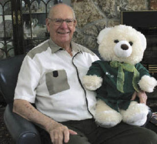 Dan Zgolinski holds a teddy bear that was given to him by a student who was accepted into his scholarship fund. Zgolinski donated $800