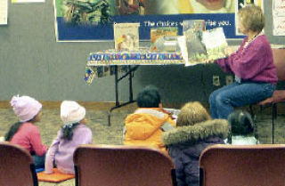 Children’s librarian Laurin Linscott reads to children at Kent Regional Library earlier this year. Linscott is gearing up for the library’s “Catch the Reading Bug” Summer Reading Program.