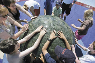 Children and adults play with a 13